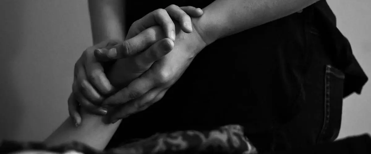 Acupuncturist holding hand of patient for pulse diagnosis