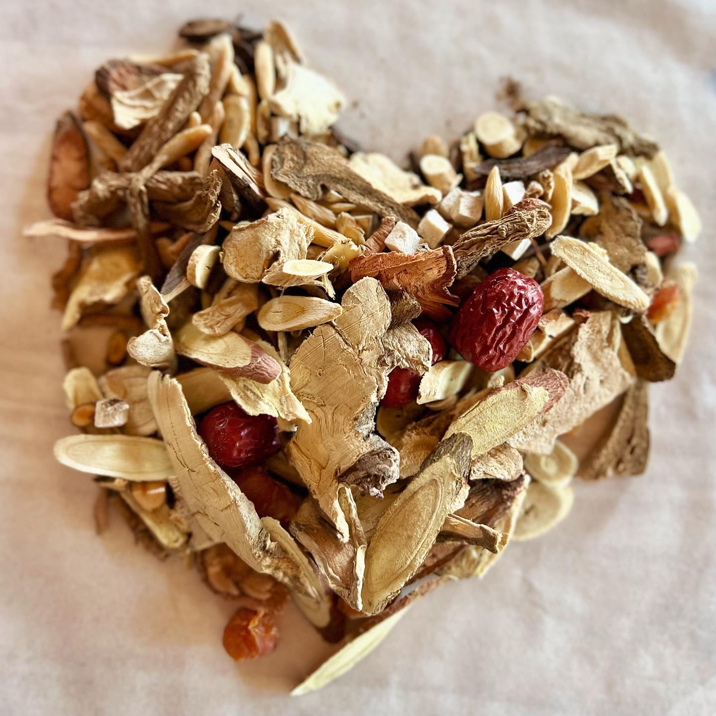 a heart shaped pile of dried herbs for treating immunity