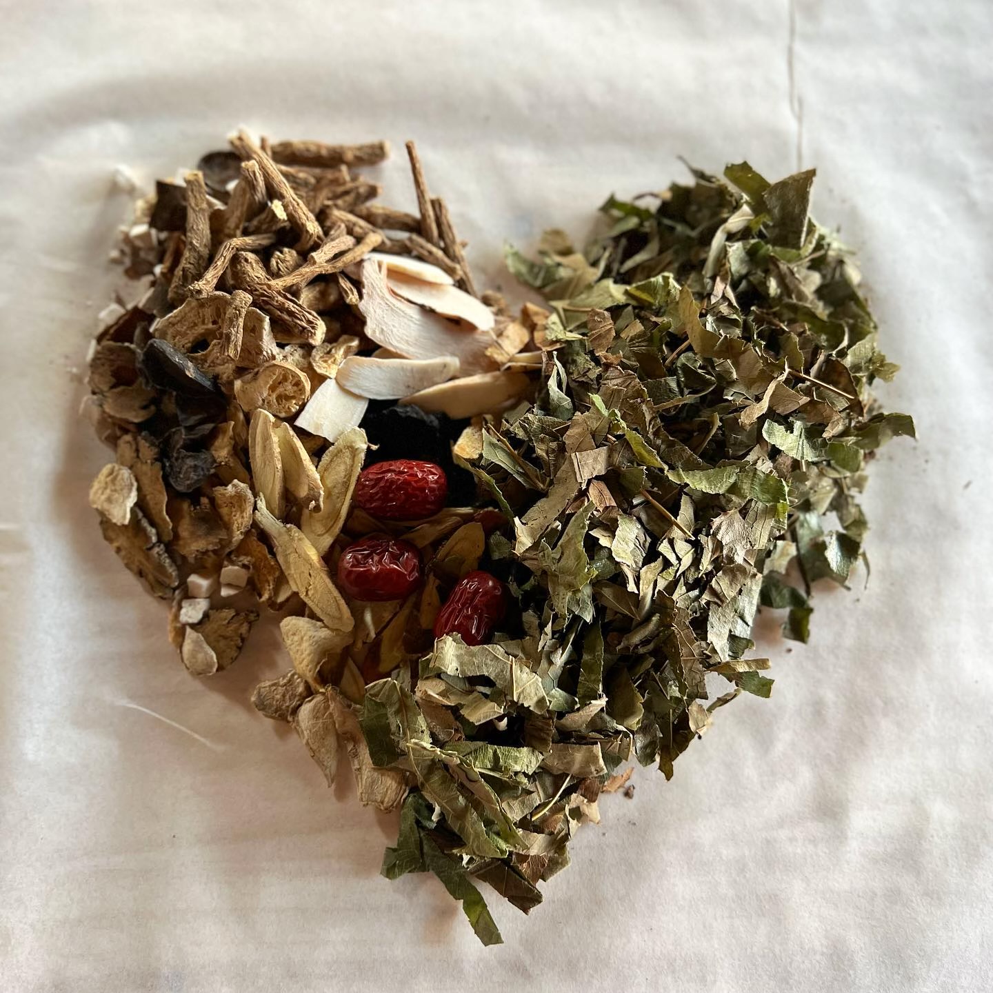 a heart shaped pile of herbs and spices