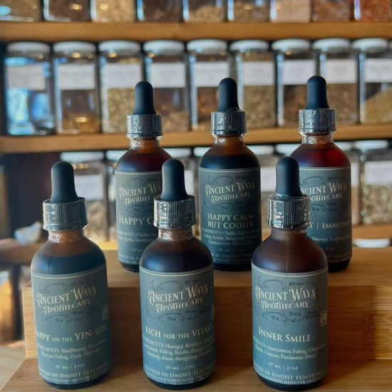 a group of bottled tinctures on a shelf in our herbal apothecary