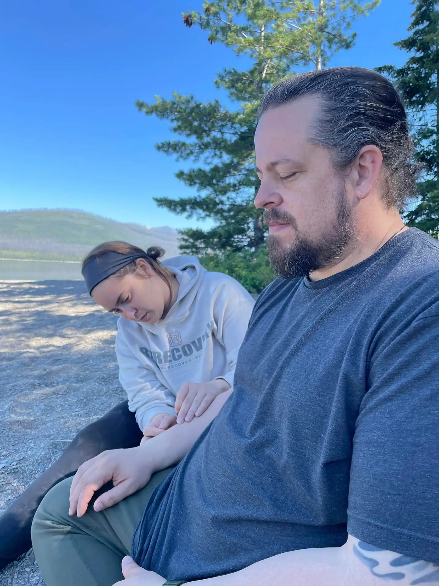 Dr Devynne Performing and acupuncture treatment on Dr James at Glacier National Park